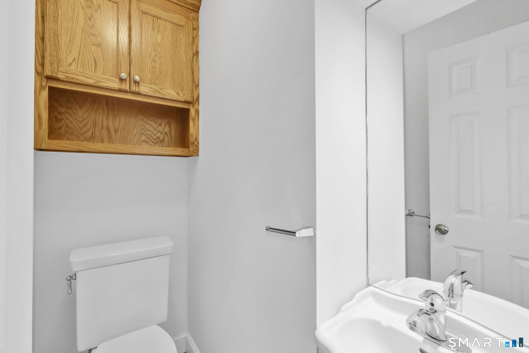 53 Alexander Street Manchester, CT 06040 - Photo 9 of 35 a bathroom with a sink a toilet and mirror