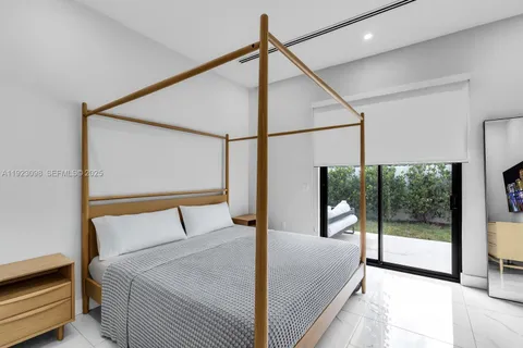 a bedroom with a bed and a mirror