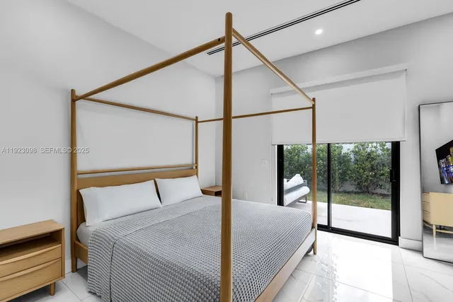 a bedroom with a bed and a mirror