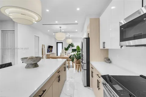 a kitchen with a stove a sink and a refrigerator