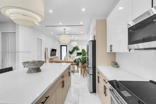a kitchen with a stove a sink and a refrigerator