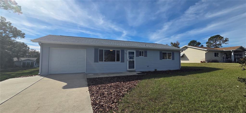 8246 Southwest 105th Place Ocala, FL 34481 - Photo 1 of 14 a front view of a house with garden