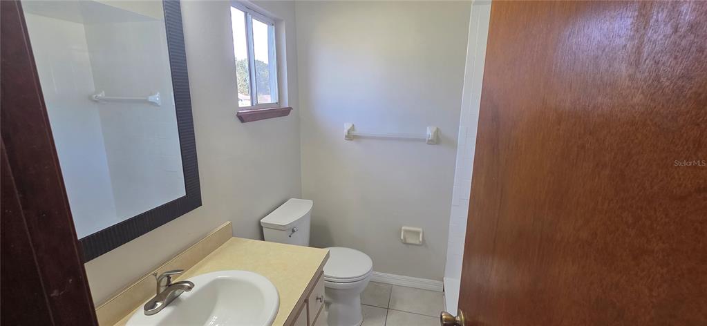 8246 Southwest 105th Place Ocala, FL 34481 - Photo 11 of 14 a white toilet sitting next to a bathroom sink