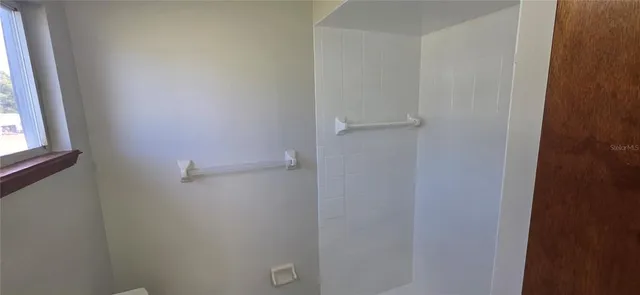 a view of a room with window and a porch