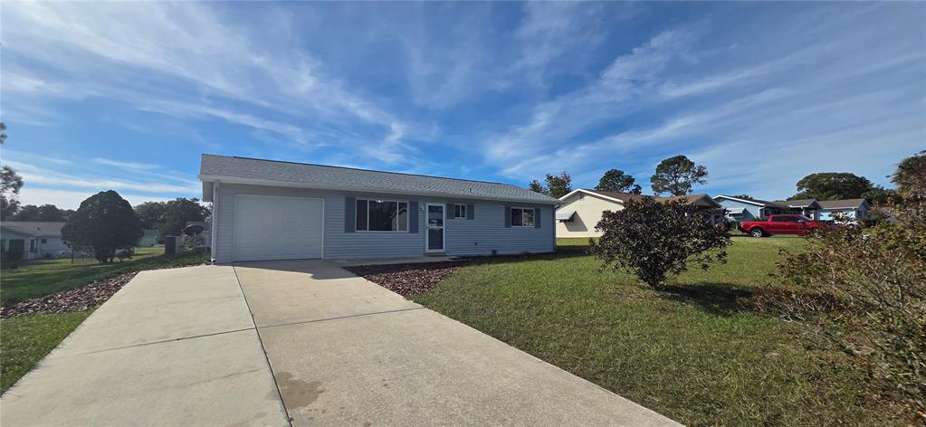 8246 Southwest 105th Place Ocala, FL 34481 - Photo 14 of 14 a front view of a house with a yard