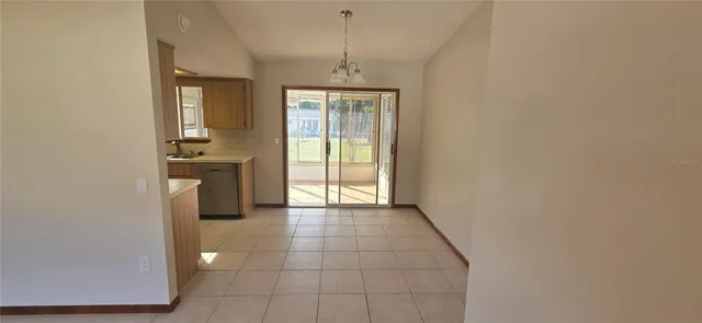 a hallway with sliding door and chandelier