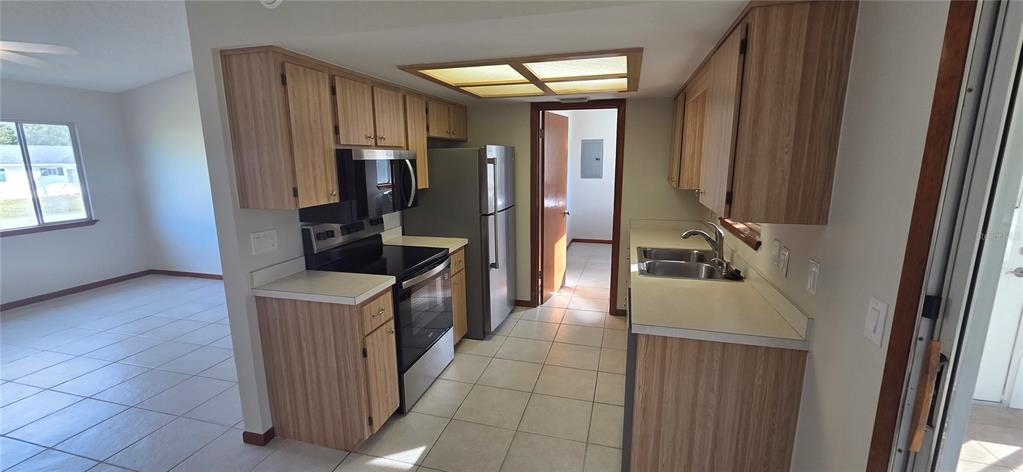 8246 Southwest 105th Place Ocala, FL 34481 - Photo 5 of 14 a kitchen with refrigerator and washer