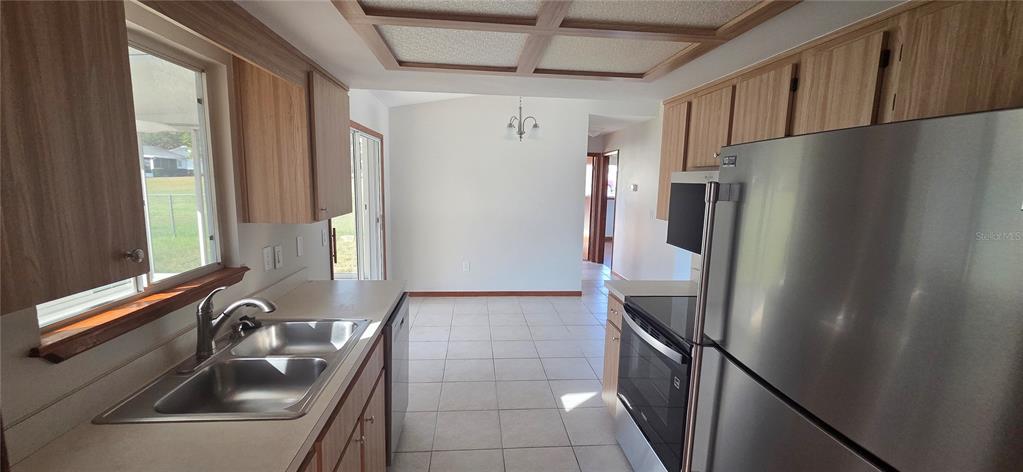 8246 Southwest 105th Place Ocala, FL 34481 - Photo 8 of 14 a kitchen with stainless steel appliances a refrigerator and a sink