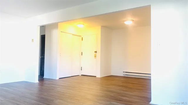 a view of a room with wooden floor