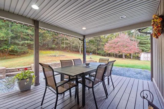 a view of outdoor sitting area with tub and fire pit
