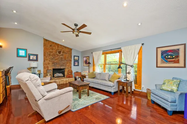 a living room with furniture a fireplace and a table