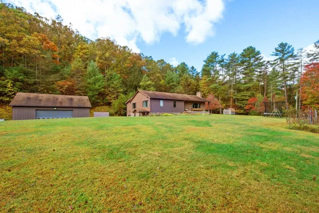 a view of a city with lush green forest
