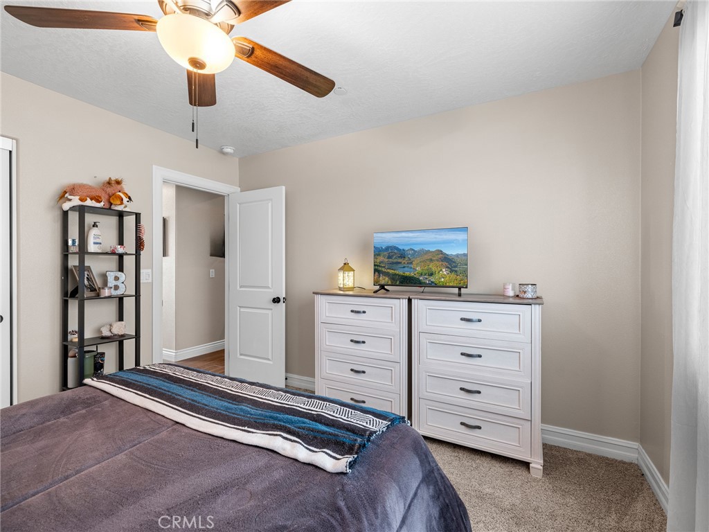 15620 Erie Road Apple Valley, CA 92307 - Photo 42 of 53 a bedroom with a bed and cabinets