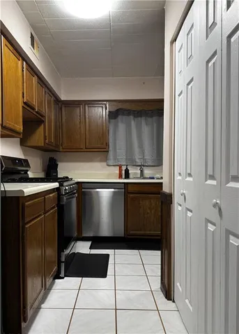 a kitchen with a sink and a refrigerator
