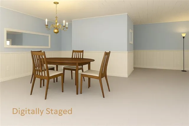 a view of a dining room with furniture and chandelier