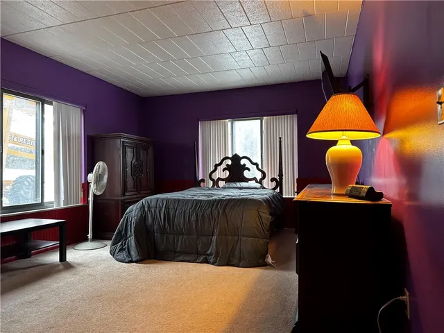 a bedroom with a bed and window