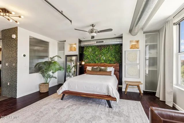 a bedroom with a bed and a potted plant