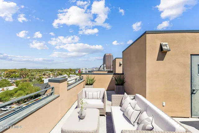 a view of a balcony with furniture