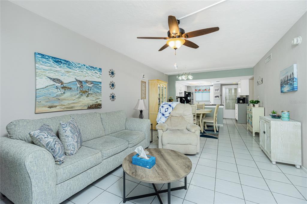 25225 Rampart Boulevard, Unit 1701 Punta Gorda, FL 33983 - Photo 8 of 21 a living room with furniture and kitchen view