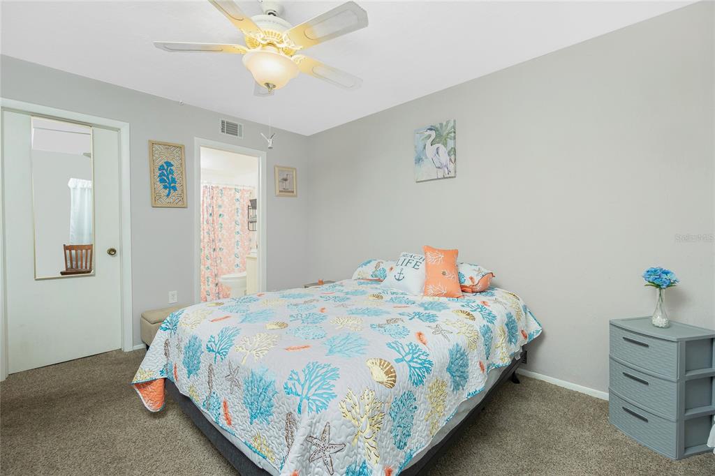 25225 Rampart Boulevard, Unit 1701 Punta Gorda, FL 33983 - Photo 9 of 21 a bedroom with a bed and a chandelier