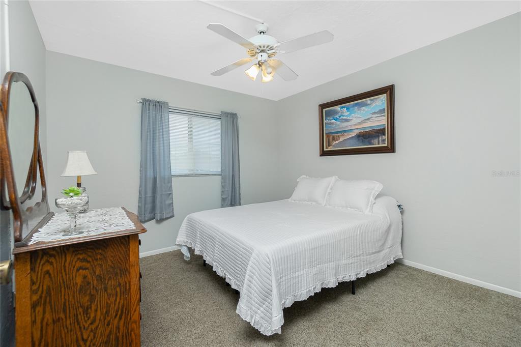 25225 Rampart Boulevard, Unit 1701 Punta Gorda, FL 33983 - Photo 10 of 21 a bed room with a bed and a chandelier