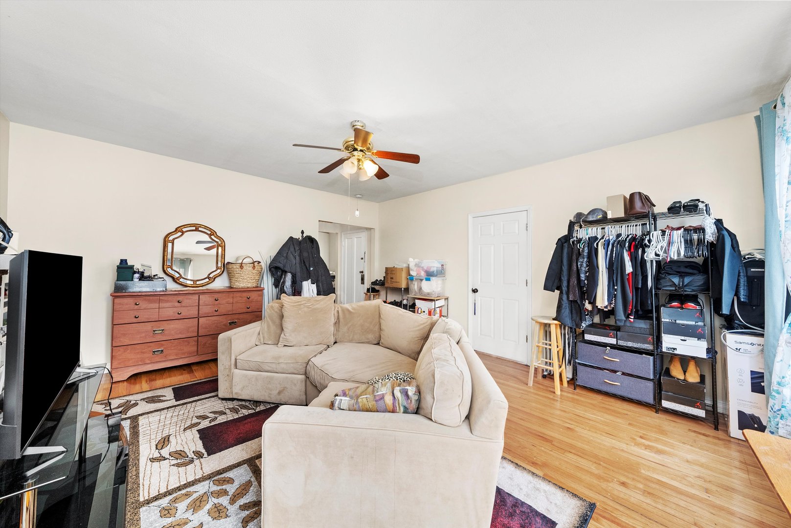 4100 West George Street Chicago, IL 60641 - Photo 11 of 49 a living room with lots of furniture and a flat screen tv