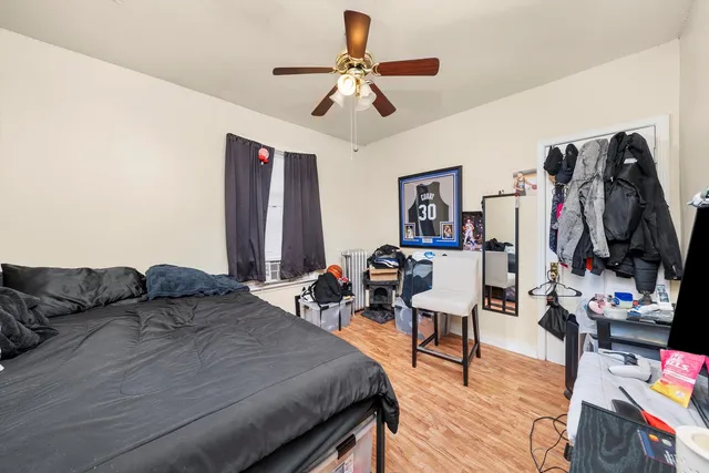 a bedroom with furniture and a flat screen tv