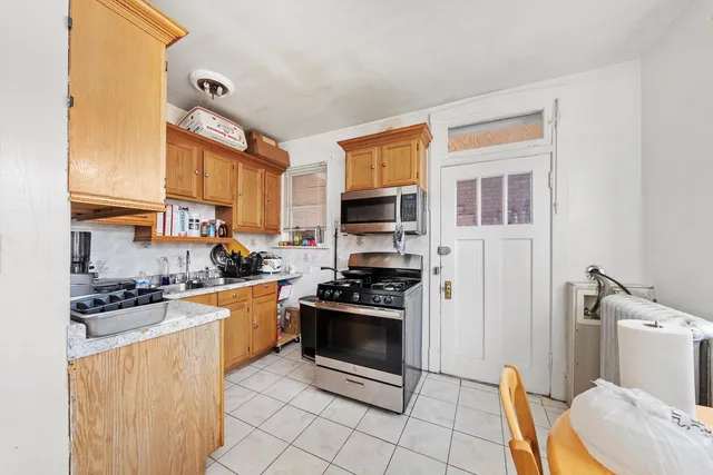 a kitchen with stainless steel appliances a stove a sink and a refrigerator