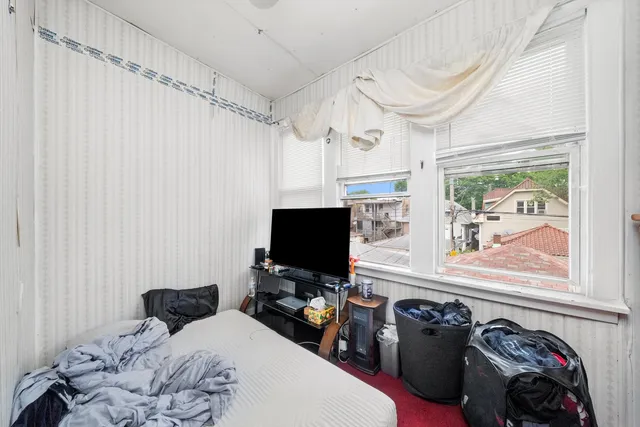 a bedroom with a bed and a flat tv screen