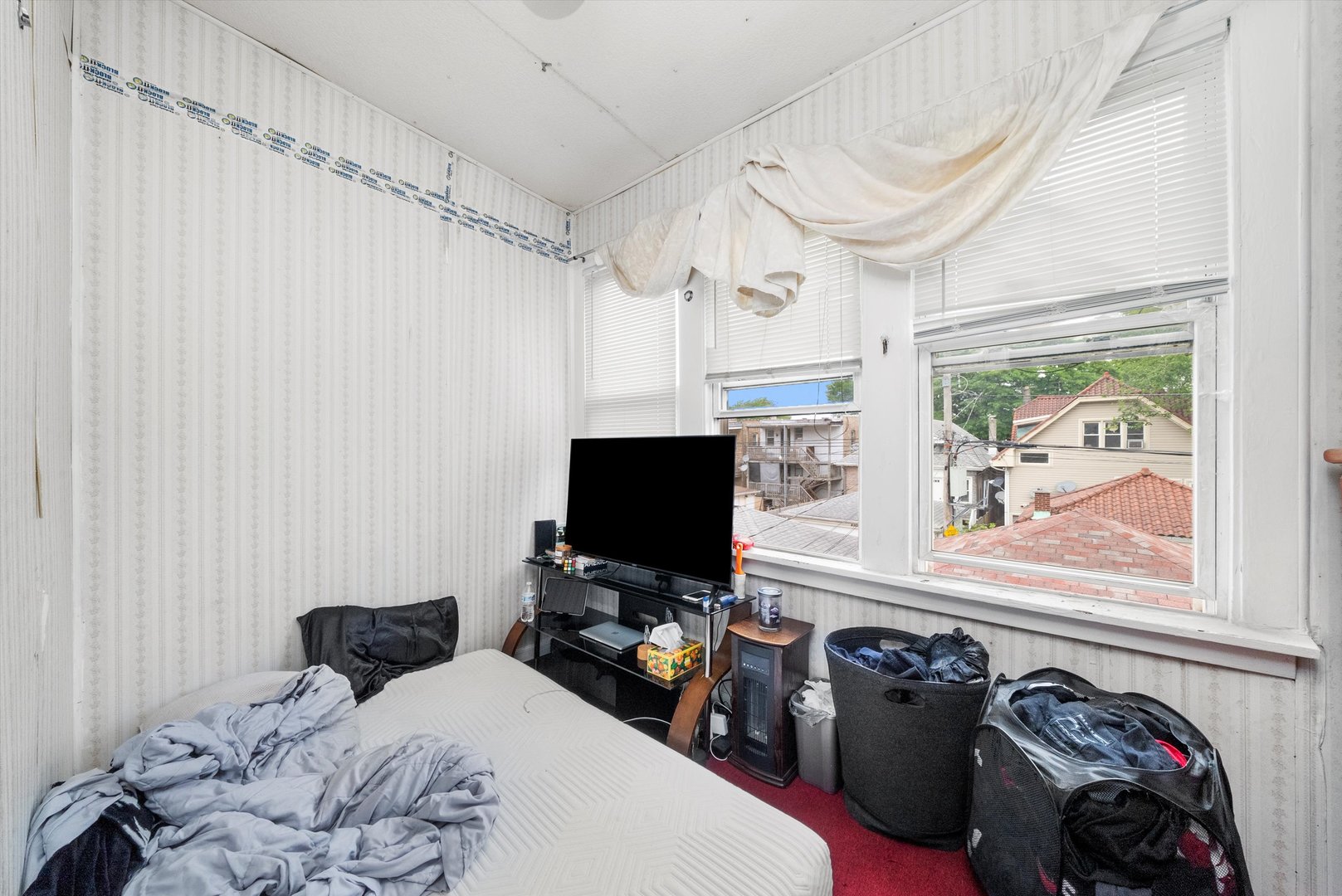 4100 West George Street Chicago, IL 60641 - Photo 19 of 49 a bedroom with a bed and a flat tv screen