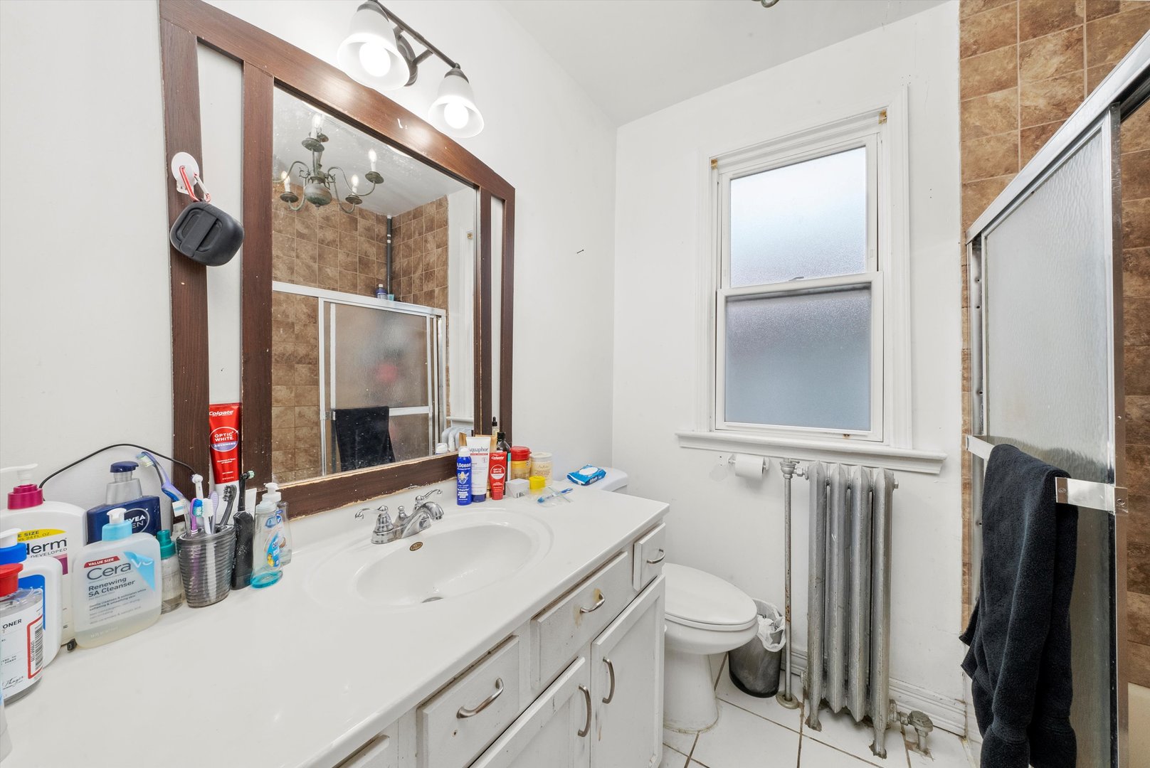4100 West George Street Chicago, IL 60641 - Photo 20 of 49 a bathroom with a double vanity sink and a mirror