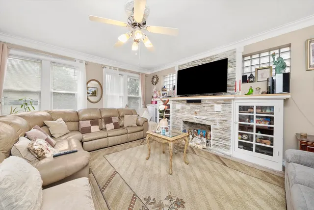 a living room with furniture a fireplace and a flat screen tv
