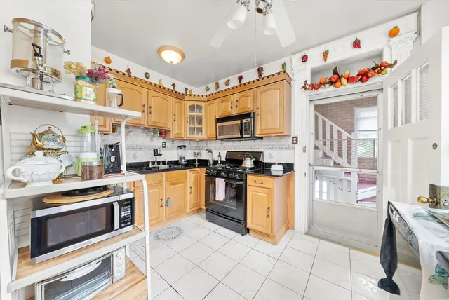 a kitchen with granite countertop stainless steel appliances a stove a sink and a refrigerator