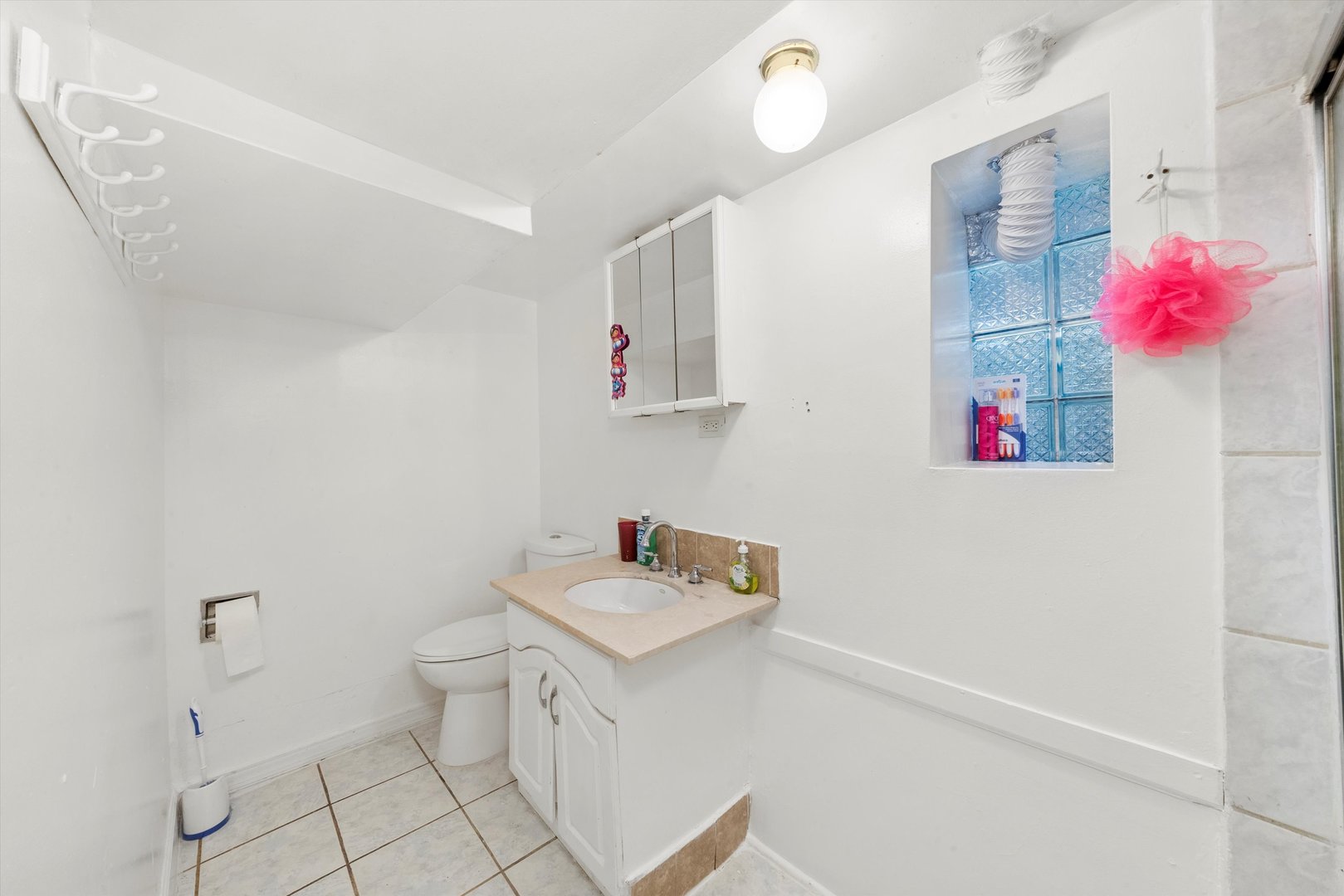 4100 West George Street Chicago, IL 60641 - Photo 34 of 49 a bathroom with a sink mirror and vanity