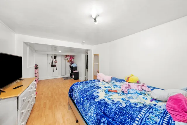 a bedroom with a bed and flat screen tv