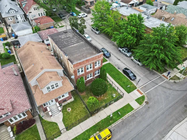 an aerial view of multiple houses with yard