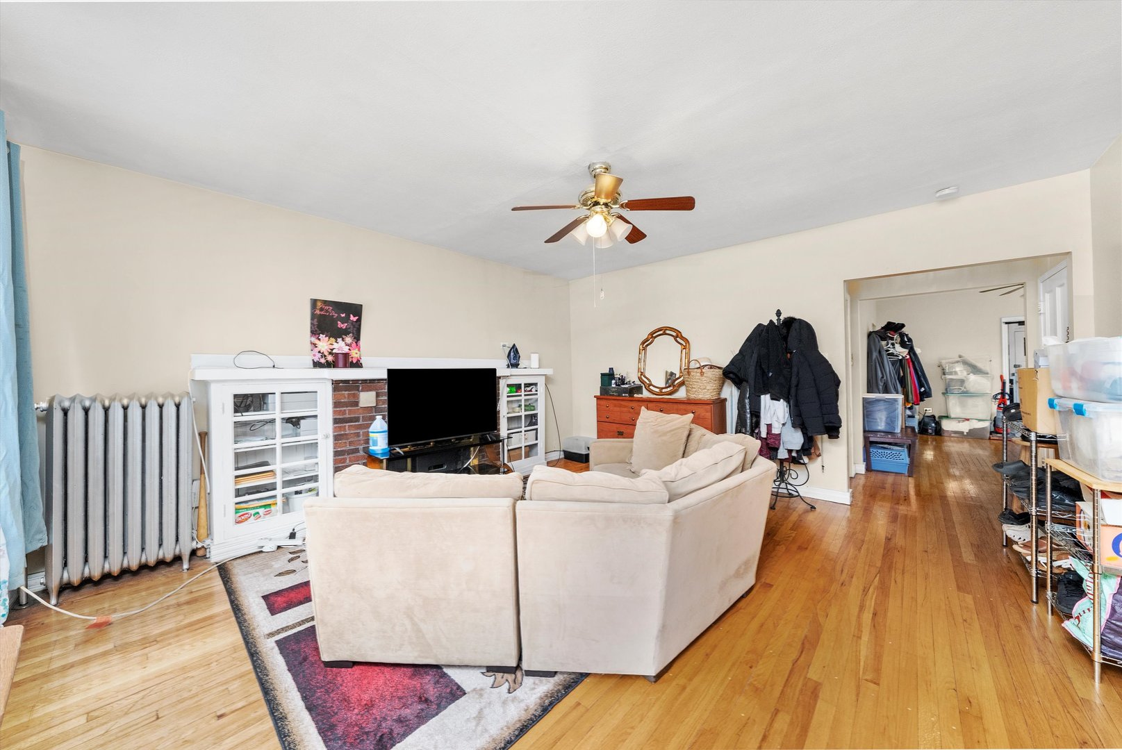 4100 West George Street Chicago, IL 60641 - Photo 7 of 49 a living room with couches a flat screen tv and kitchen view