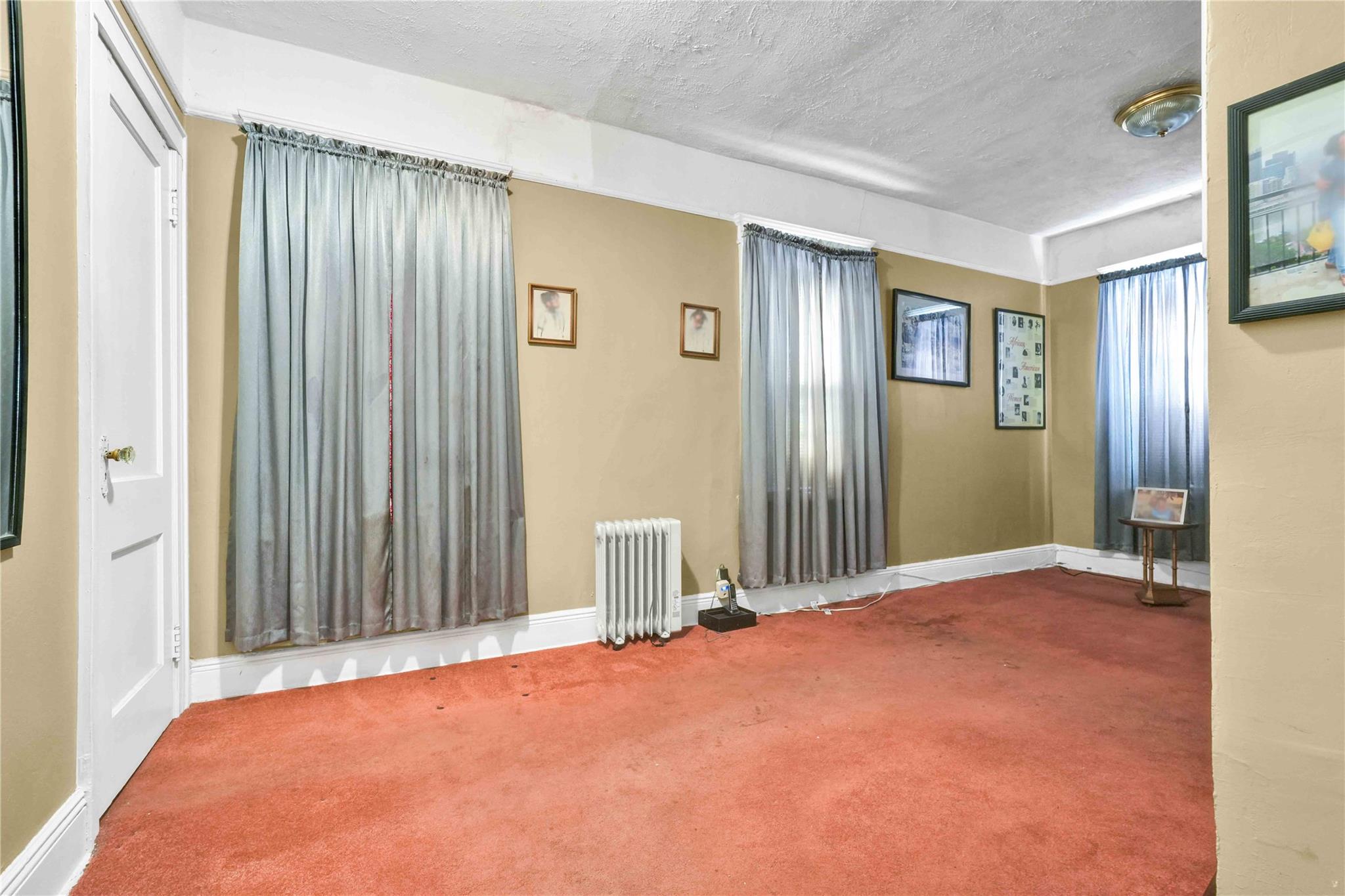 9908 35th Avenue Queens, NY 11368 - Photo 11 of 22 a view of a livingroom with a staircase