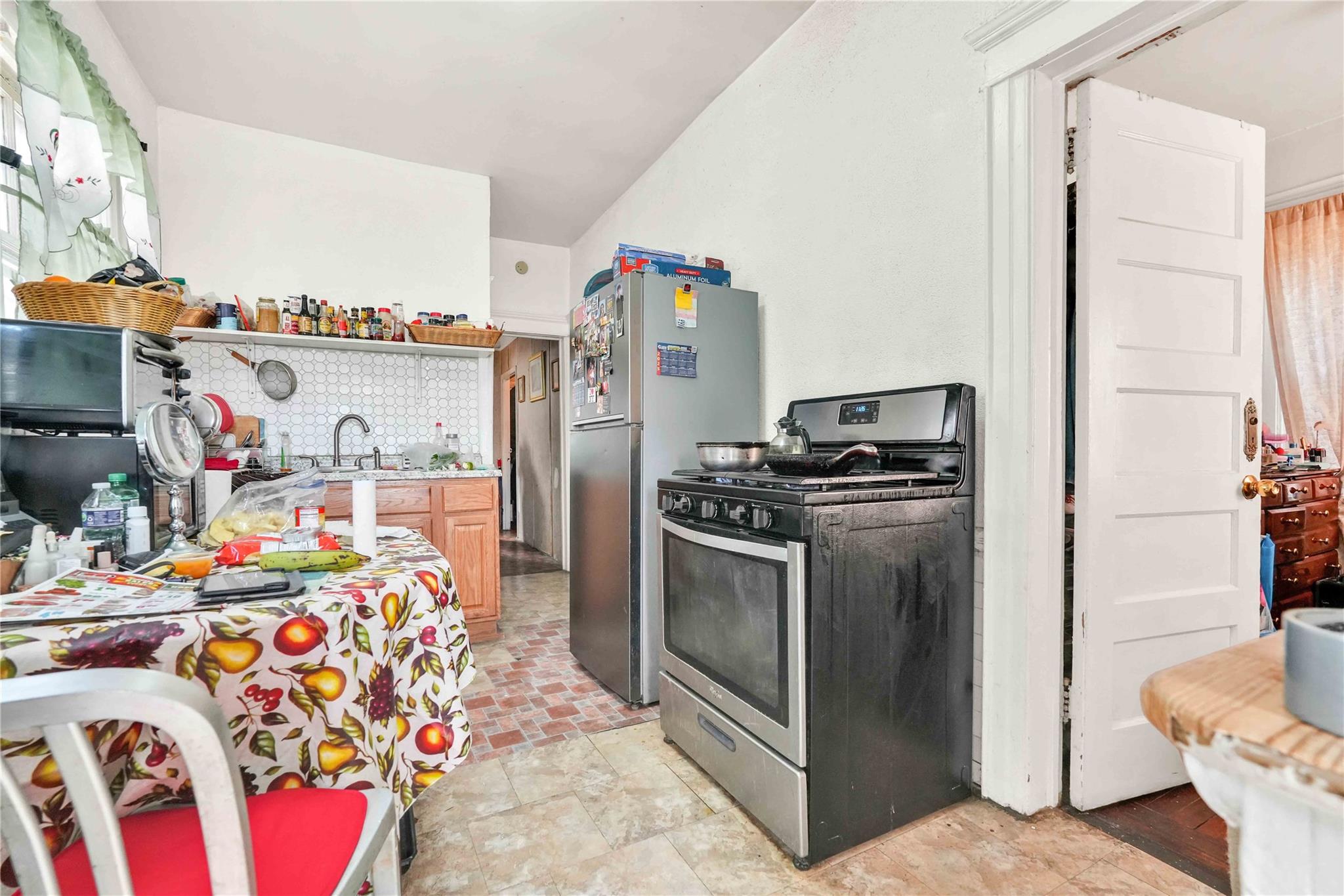9908 35th Avenue Queens, NY 11368 - Photo 13 of 22 a kitchen with stainless steel appliances and a chimney