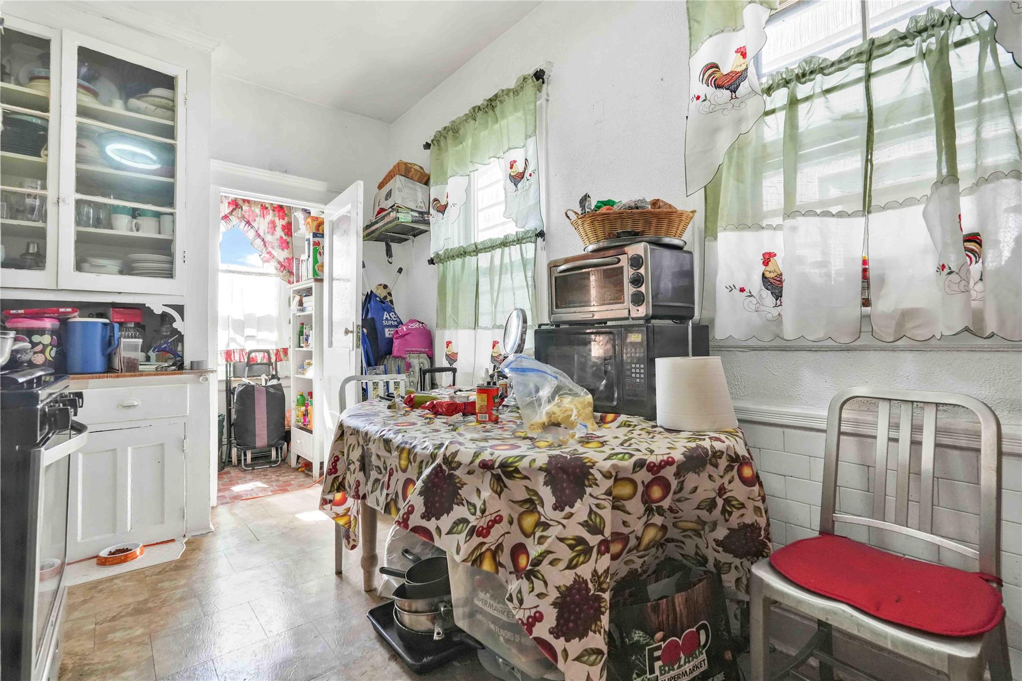 9908 35th Avenue Queens, NY 11368 - Photo 17 of 22 a bed room with a bed mirror and a window