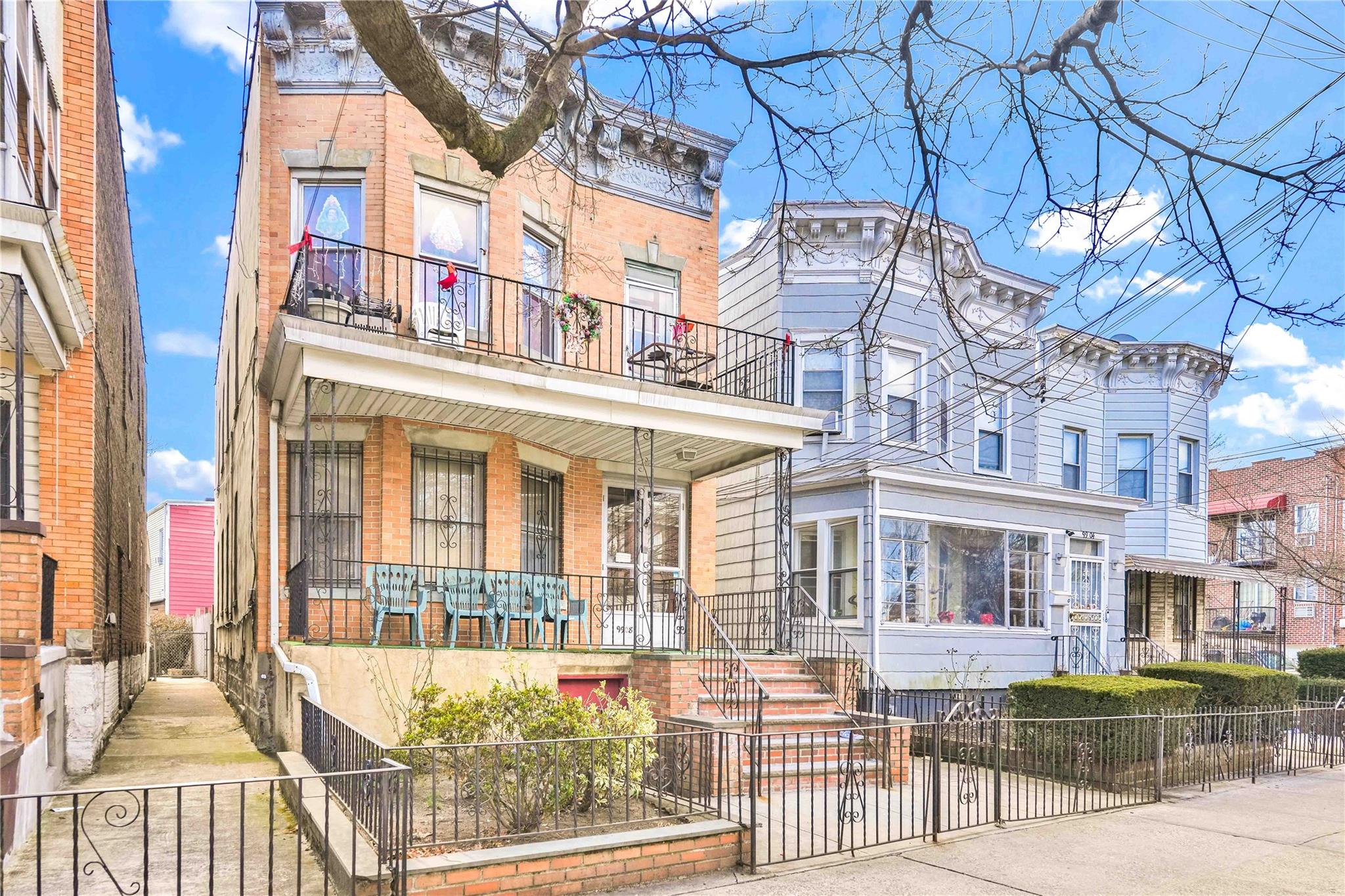 9908 35th Avenue Queens, NY 11368 - Photo 2 of 22 a front view of a building and a yard