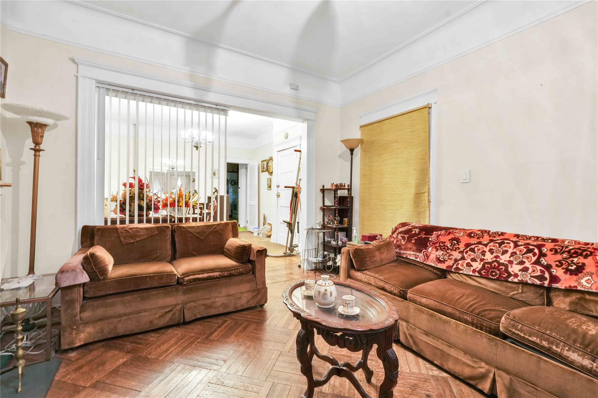 9908 35th Avenue Queens, NY 11368 - Photo 5 of 22 a living room with furniture and a large window