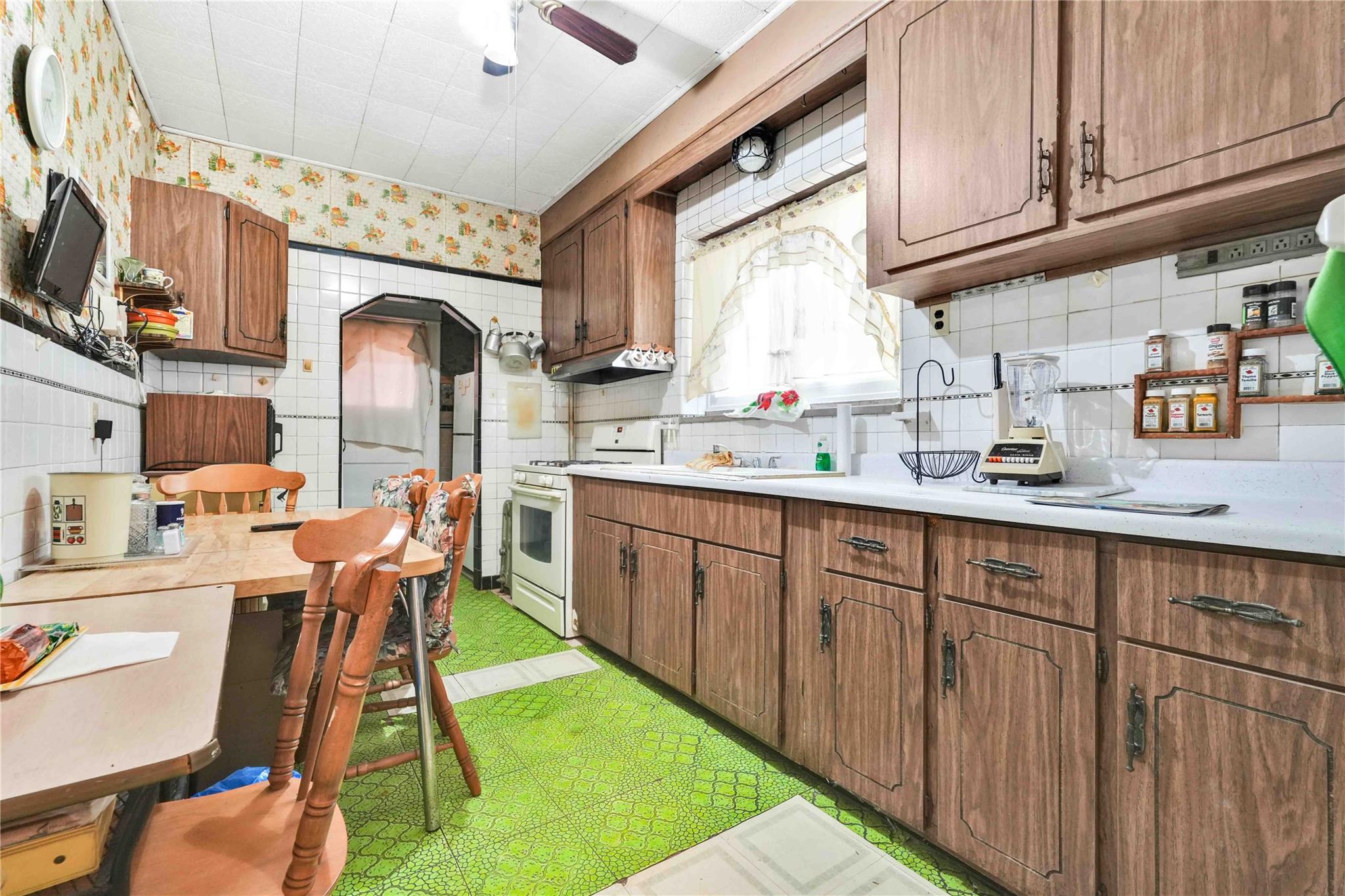 9908 35th Avenue Queens, NY 11368 - Photo 7 of 22 a kitchen with stainless steel appliances granite countertop a sink dishwasher and cabinets with wooden floor
