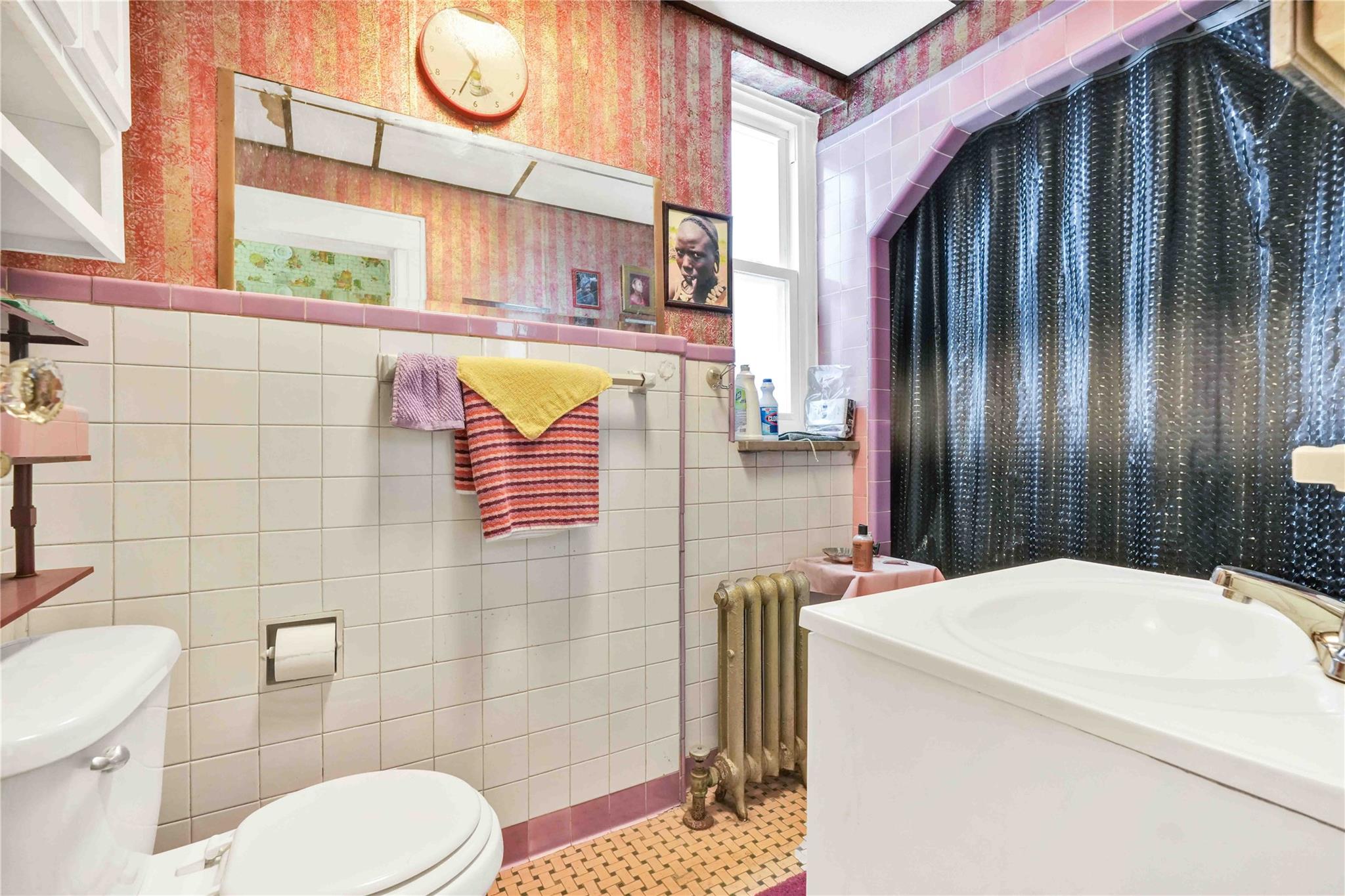 9908 35th Avenue Queens, NY 11368 - Photo 9 of 22 a bathroom with a sink toilet and shower