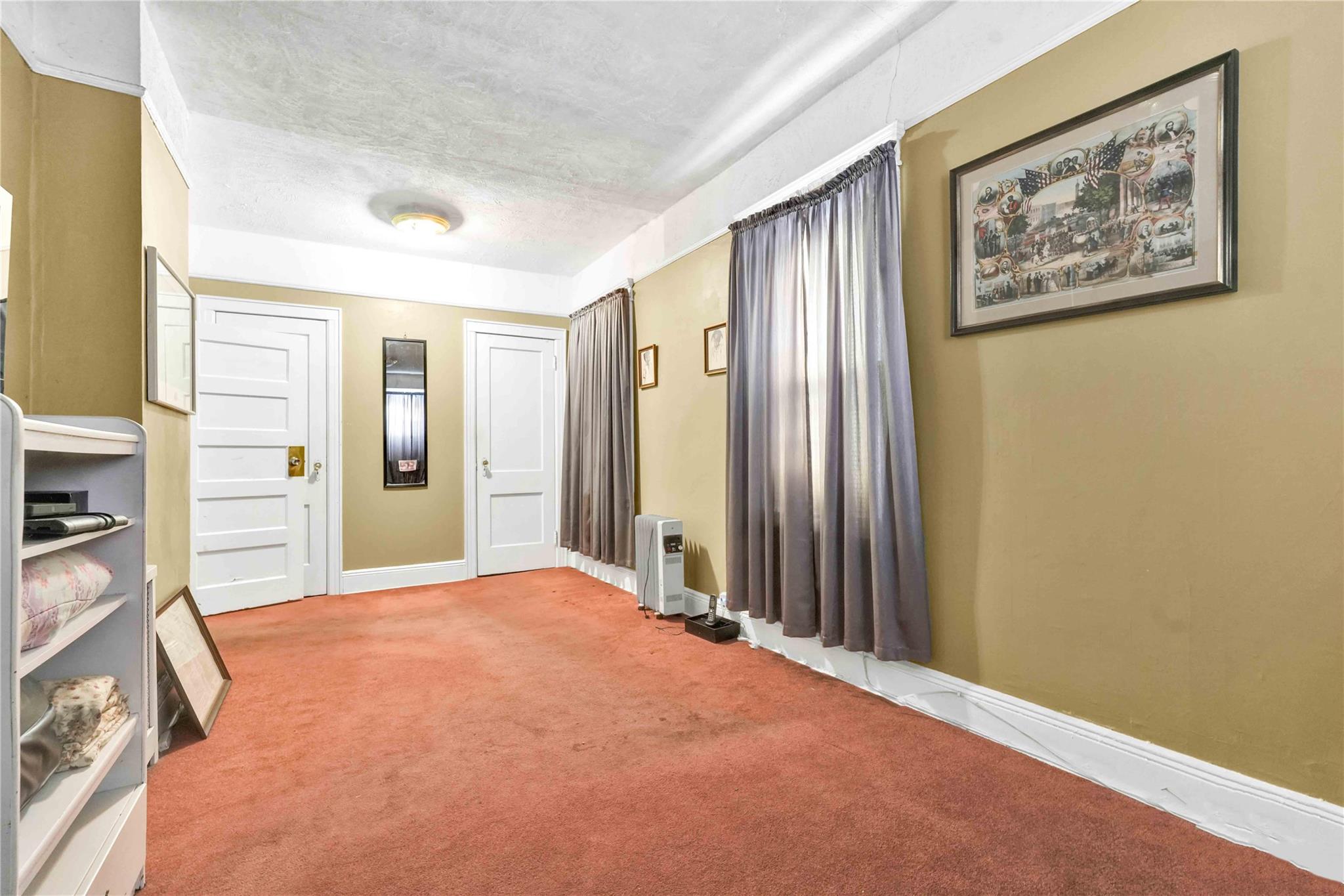 9908 35th Avenue Queens, NY 11368 - Photo 10 of 22 an empty room with closet and bathroom