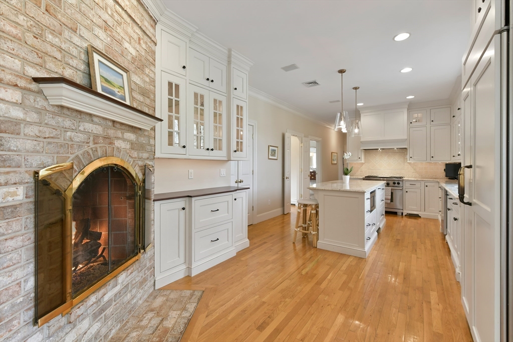 11 Olmsted Drive Hingham, MA 02043 - Photo 11 of 36 a open kitchen with cabinets a sink and a stove