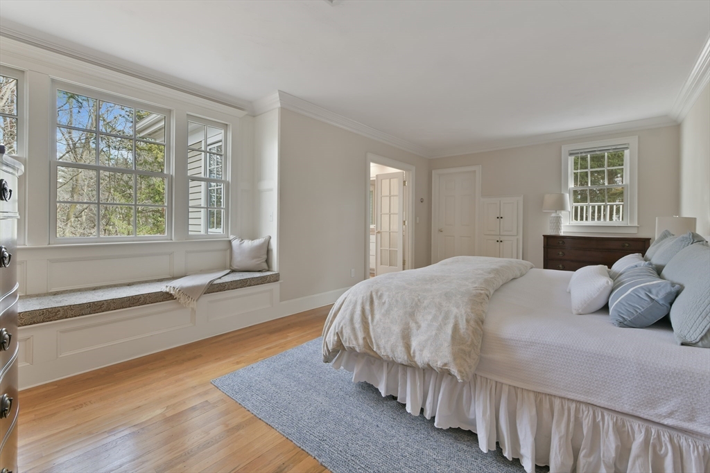 11 Olmsted Drive Hingham, MA 02043 - Photo 20 of 36 a bedroom with a bed and a large window with wooden floor