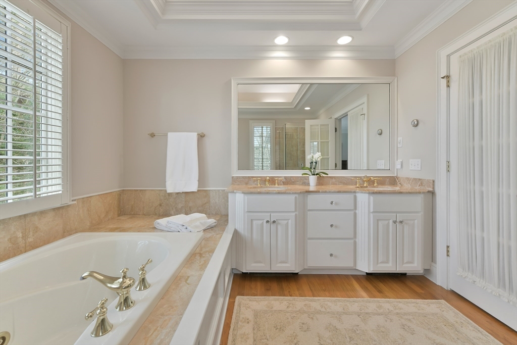 11 Olmsted Drive Hingham, MA 02043 - Photo 21 of 36 a spacious bathroom with a granite countertop tub double vanity and a mirror