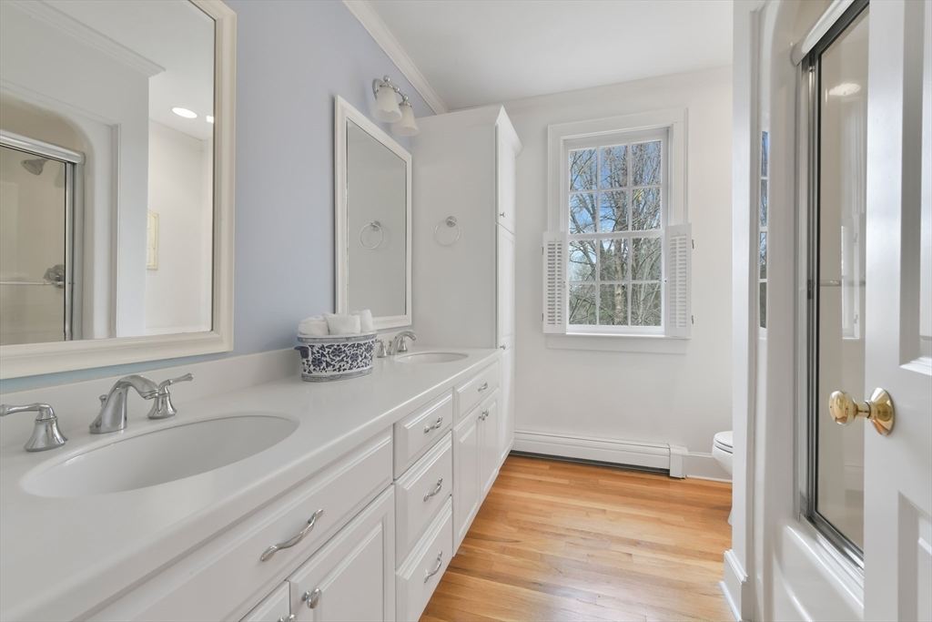 11 Olmsted Drive Hingham, MA 02043 - Photo 24 of 36 a bathroom with a double vanity sink and a mirror