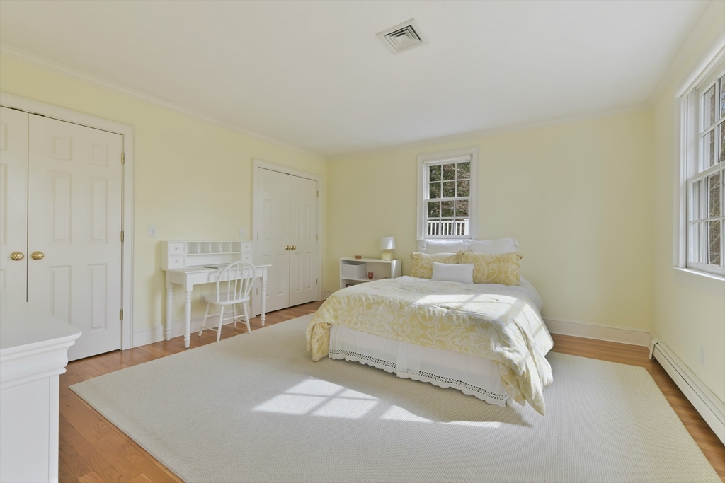 11 Olmsted Drive Hingham, MA 02043 - Photo 25 of 36 a bedroom with a bed and a cabinets